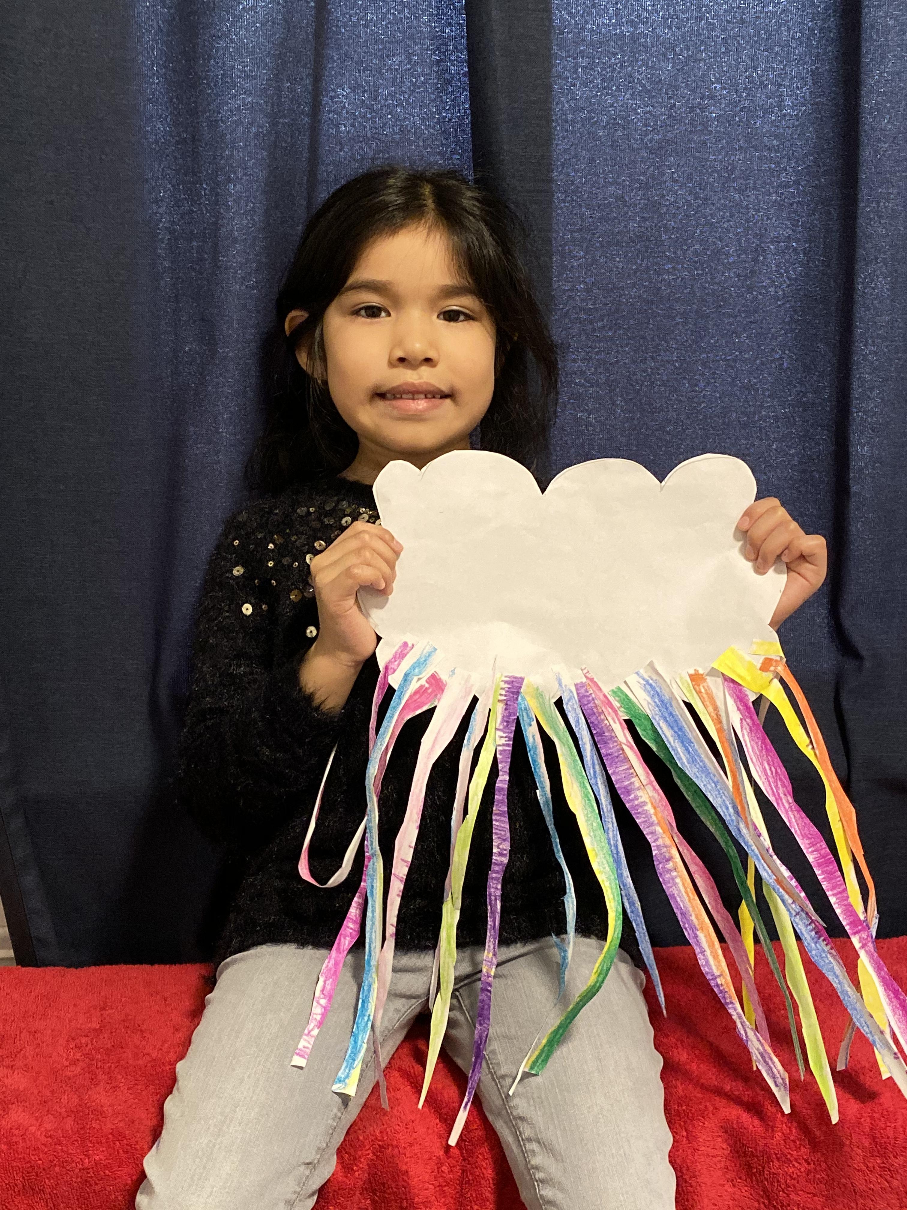 girl holding cloud with multicolored pastel string